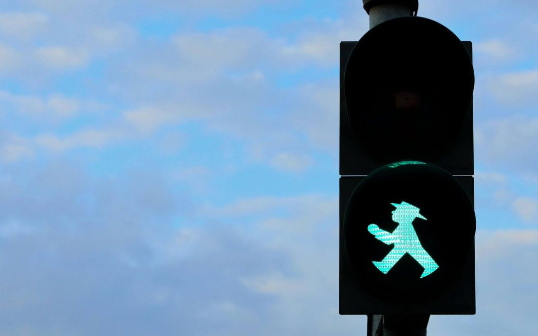 A pedestrian traffic light showing the green walking person