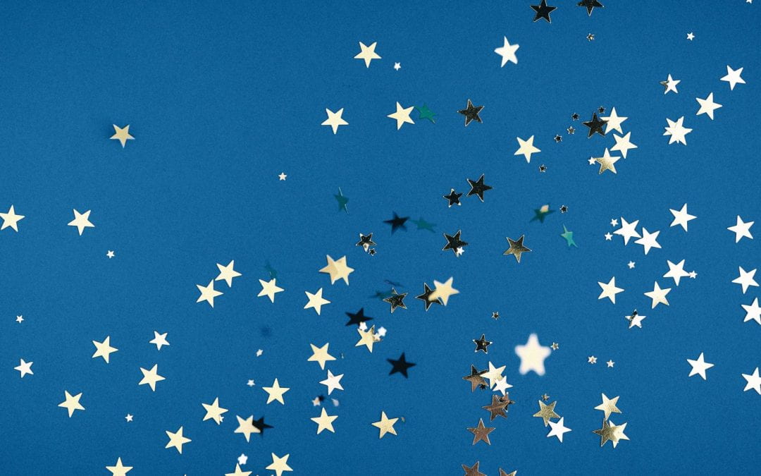Silver star confetti on a blue background