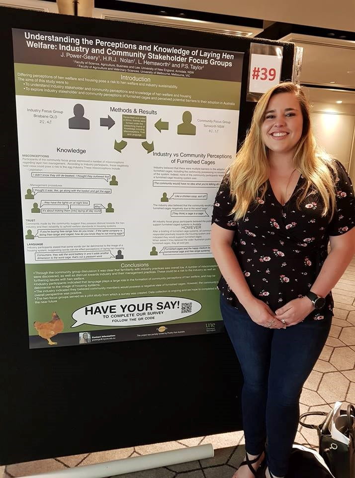 Jennifer Power-Geary smiles in front of her research poster at the Australian Poultry Science Symposium