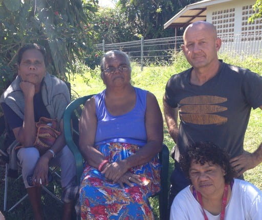 Informal group image of Nick Reid with members of the Aboriginal Nauiyu community.