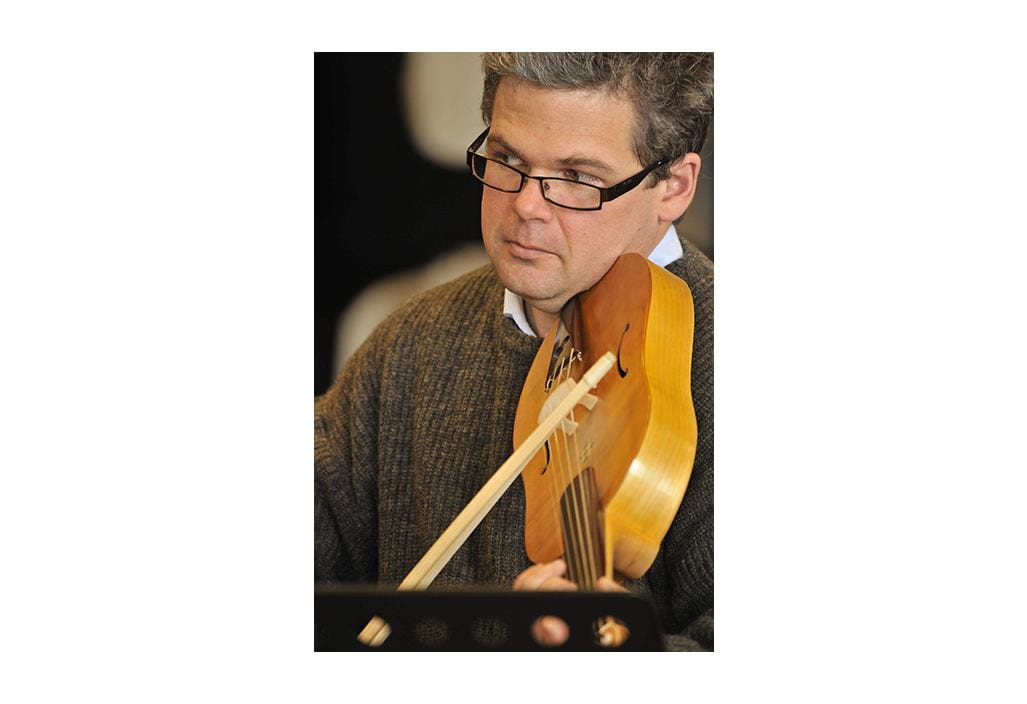 Jason Stoessel plays a reconstructed 'vielle' or 'viella', a stringed violin-like medieval instrument.