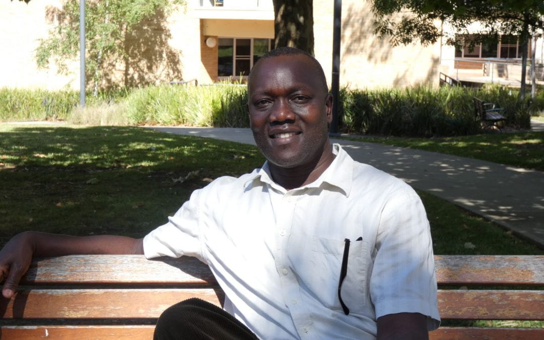 Casual portrait image of peace studies PhD candidate Sam Onapa