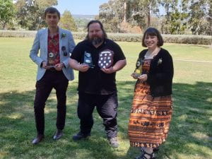 Dr. James Roberts, Daniel J. Leahy, and Meaghan ‘May’ Zarb with the three ‘Clubbie’ trophies awarded to the UNE Archaeology Society in October 2020. (Photo by the UNE Photography Society).