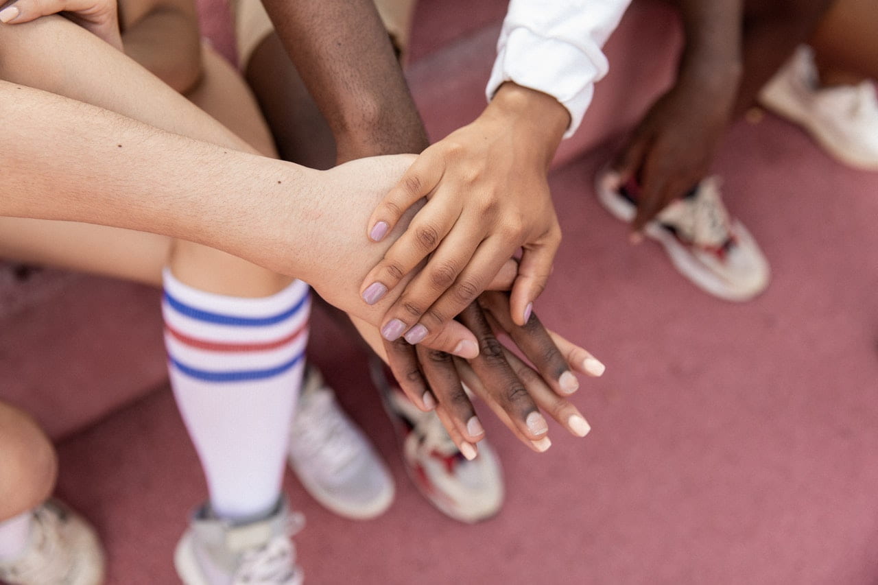 Close-up of the hands of a multiracial sport team stacked for encouragement