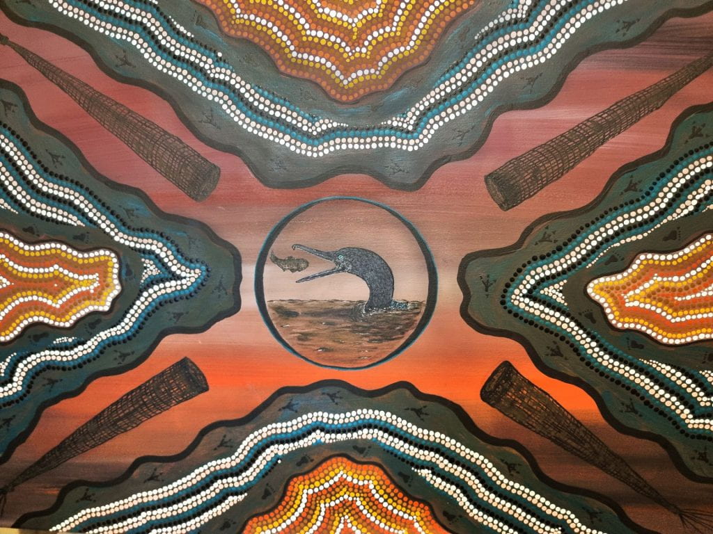 Artwork featuring traditional Aboriginal dot technique with a bird eating fish as the focal point