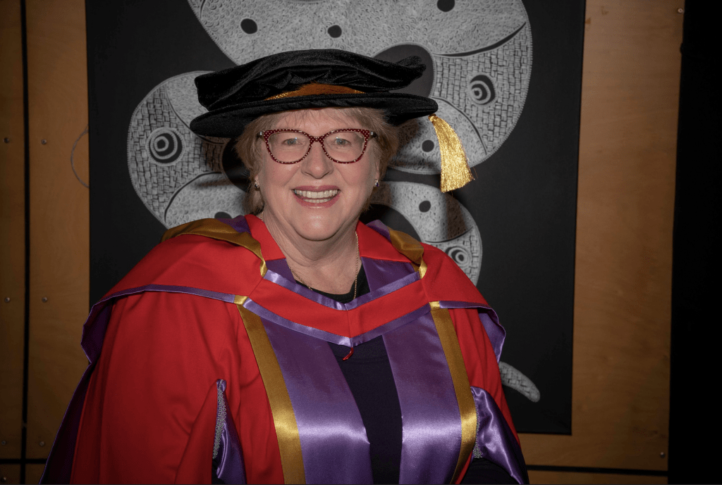 Dr Barb Bannister, UNE Lecturer, in graduation robes for the academic procession in August 2022