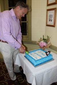 Professor Mark Perry cutting the Anniversary cake