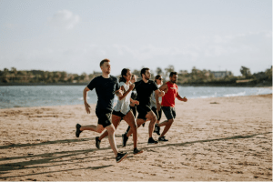 A group of young people running on a beach