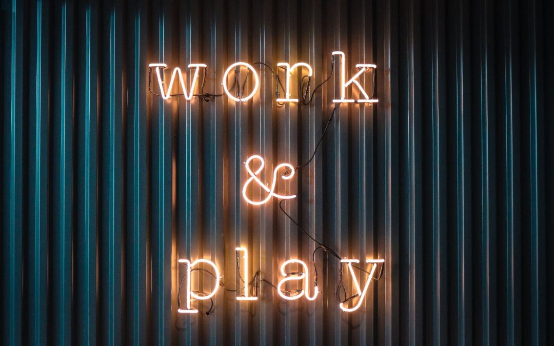 Work & Play in lit up lettering on corrugated iron backdrop