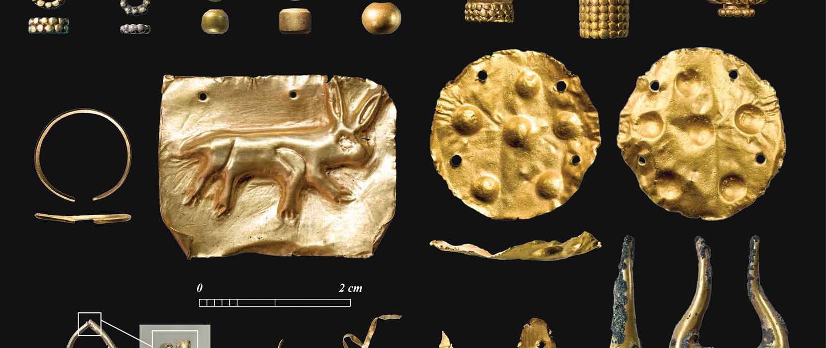 Gold and electrum jewellery excavated from the sands of Saruq al Hadid on a black background
