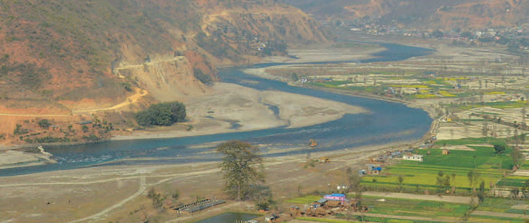 A river running through the Koshi river basin landscape.